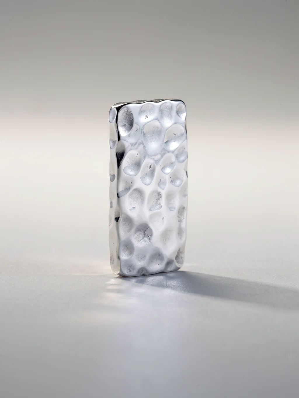 Hand-hammered heavy sterling silver pendant necklace on natural linen
